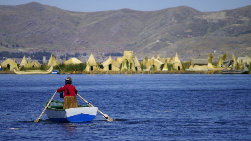 Woman rowing on Lake Titicaca near the floating islands