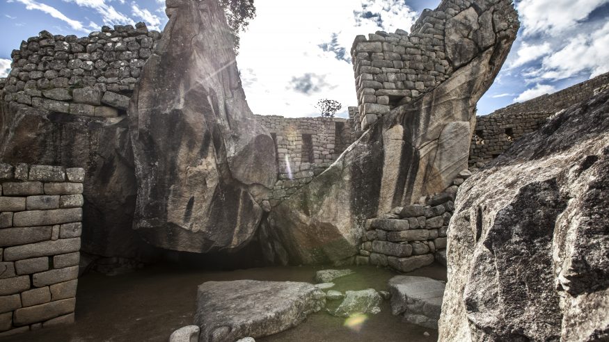 Sun behind the ruins at Machu Picchu