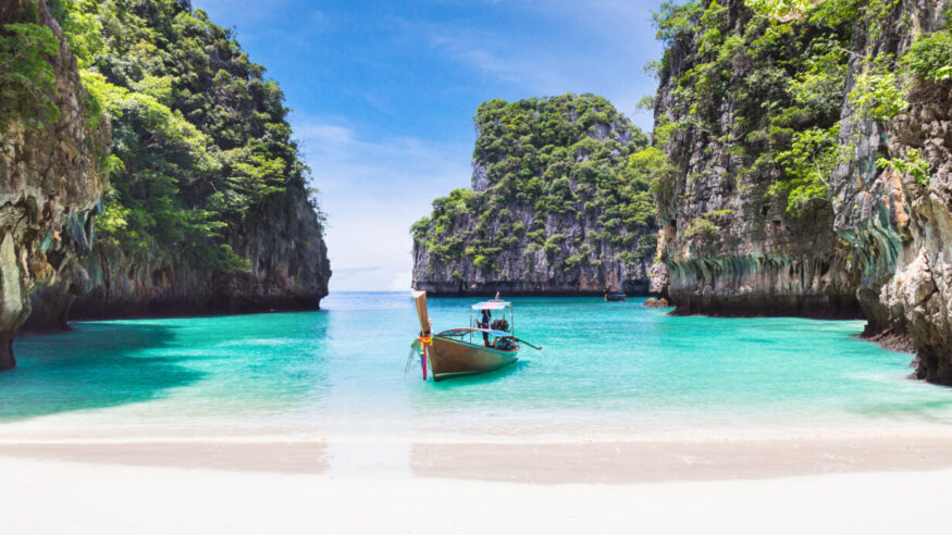The Thai traditional wooden longtail boat and beautiful beach in Phuket province, Thailand.