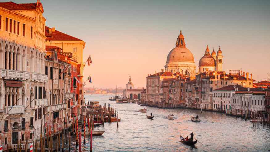 Grand Canal and Basilica Santa Maria della Salute in Venice, Italy. Beautifil cityscape at sunset. Famous tourist destination.
