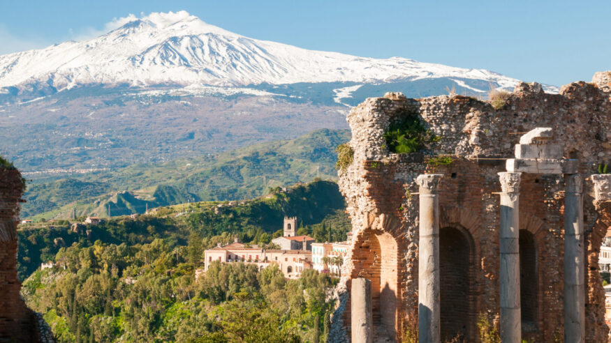 View of some columns in the stage of the greek theater in Taormina and a perspective of snowy mount EtnaView of some columns in the stage of the greek theater in Taormina and a perspective of snowy mount EtnaView of some columns in the stage of the greek theater in Taormina and a perspective of snowy mount Etna