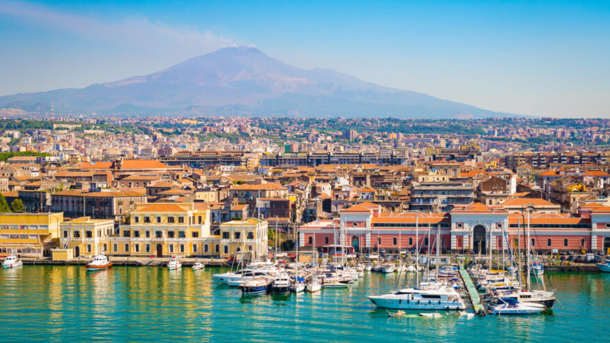 Beautiful view of Catania cruise port with smoking volcano Etna in the background.