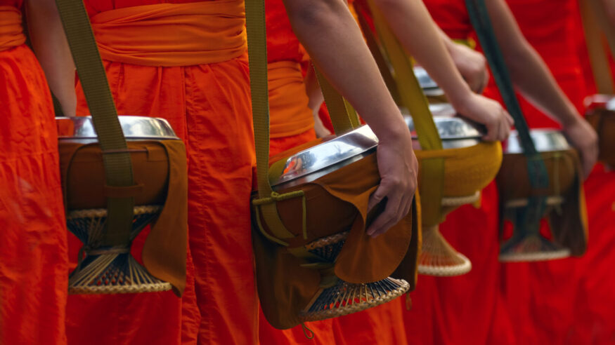 More monk with almsbowl at morning time ,the peaple put food offerings into a Buddhist monk's bowl,Luang Prabang ,Laos world Culture Heritage Site