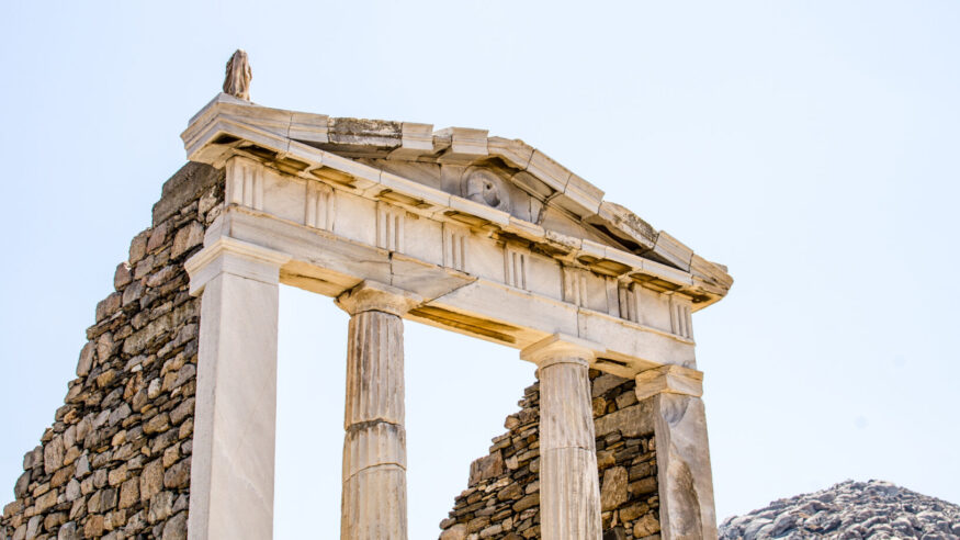 ruins of classical greek architecture carved in marble on the island of delos near mykonos in greece