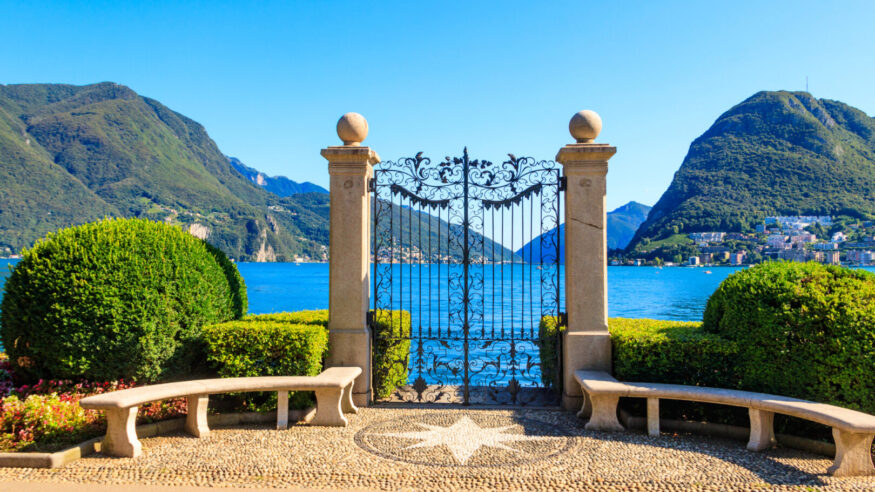 Old wrought iron gate overlooking Lake Lugano in Ciani Park, Lugano, Switzerland