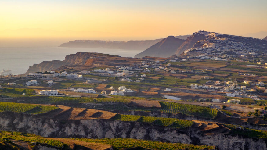 Landscape view of fields, vineyards and greek villages Fira and Oia on Santorini island, Greece